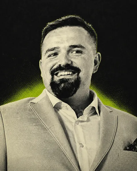 Emanuel Quimper smiling in a graphite and volt portrait